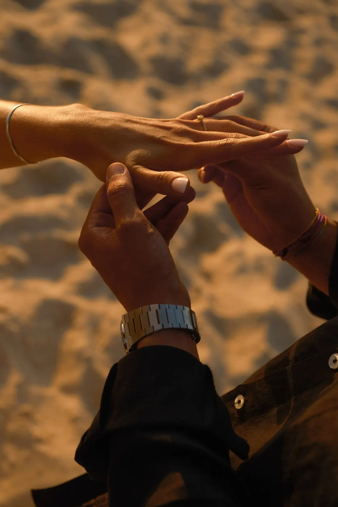 The moment he slides the ring onto her finger